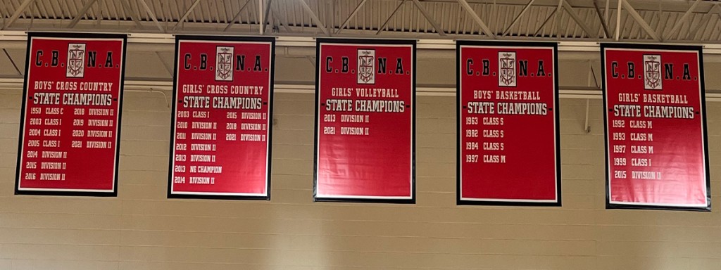 Coe-Brown championship banners hanging in the gymnasium